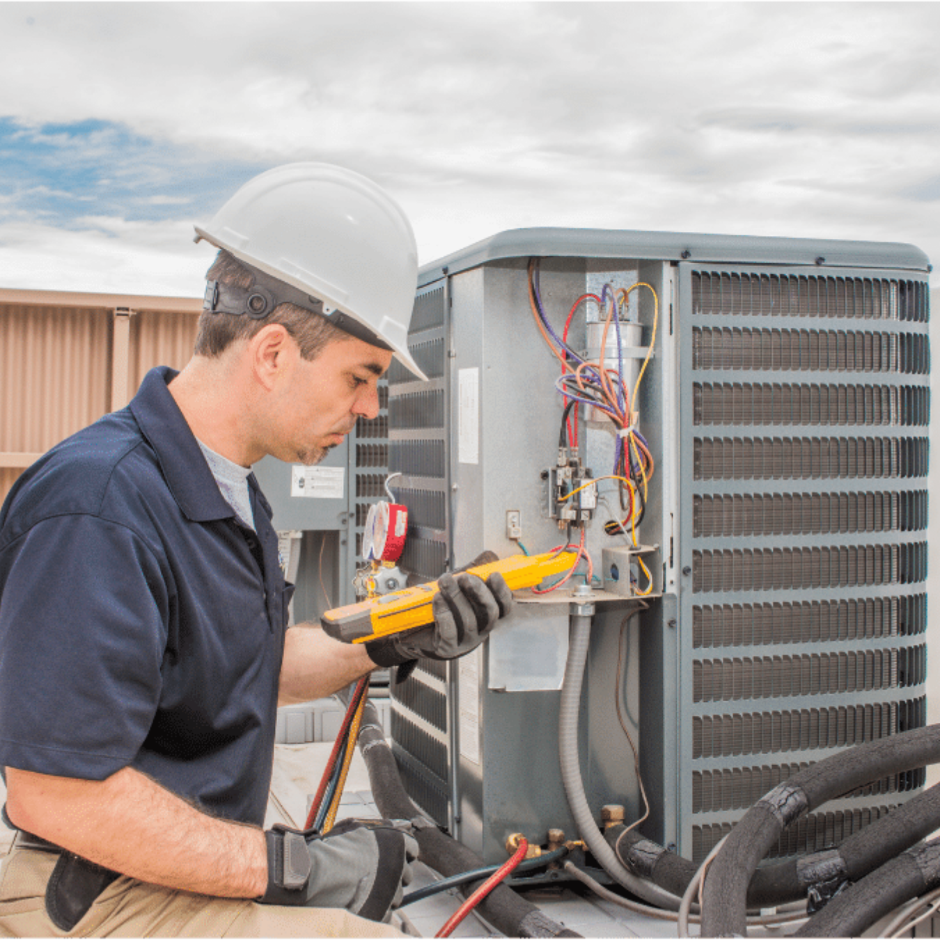 Tillsonburg Heating & Cooling HVAC technician servicing a system