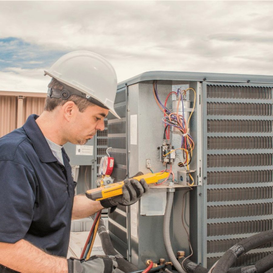 Tillsonburg Heating & Cooling HVAC technician servicing a system